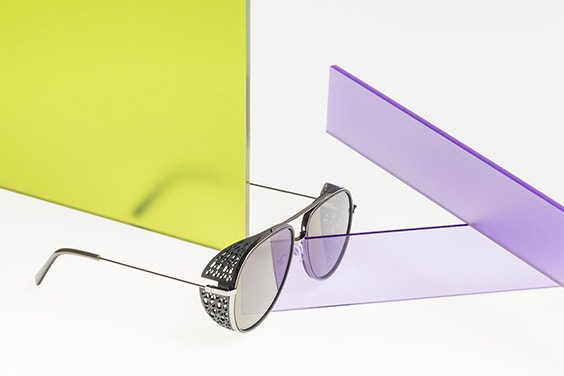 3D-printed sunglasses from Safilo OXYDO angledd and surrounded by colorful glass