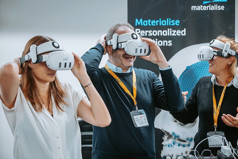 Three Materialise CMF Innovation Summit attendees wearing extended reality goggles
