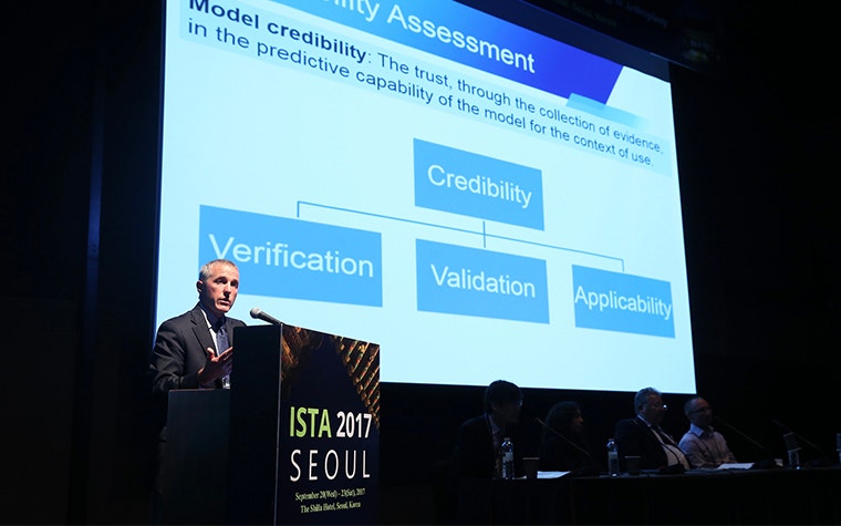 A man at a podium at the ISTA 2017 conference in front of a slide on credibility assessment 