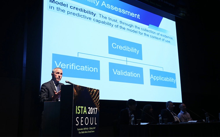 A man at a podium at the ISTA 2017 conference in front of a slide on credibility assessment