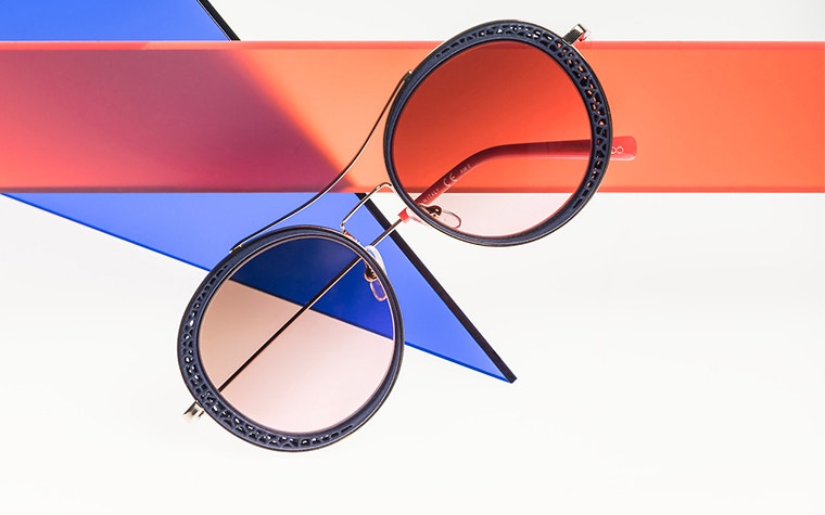 Tilted view of folded up, circular, 3D-printed sunglasses from Safilo OXYDO
