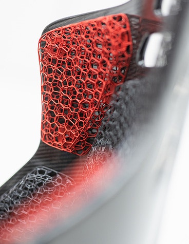 Side view of a car seat that uses a 3D-printed lattice structure