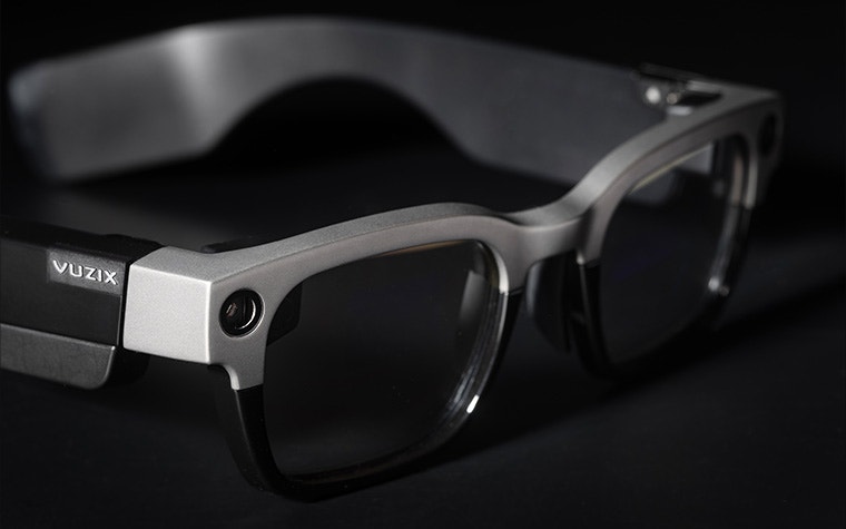 A side-on view of the Vuzix Shield, bifocal smart glasses with a 3D-printed titanium frame.