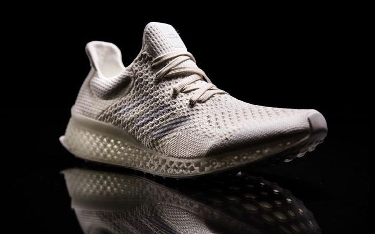 A white Adidas Futurecraft sports shoe with a 3D-printed midsole.