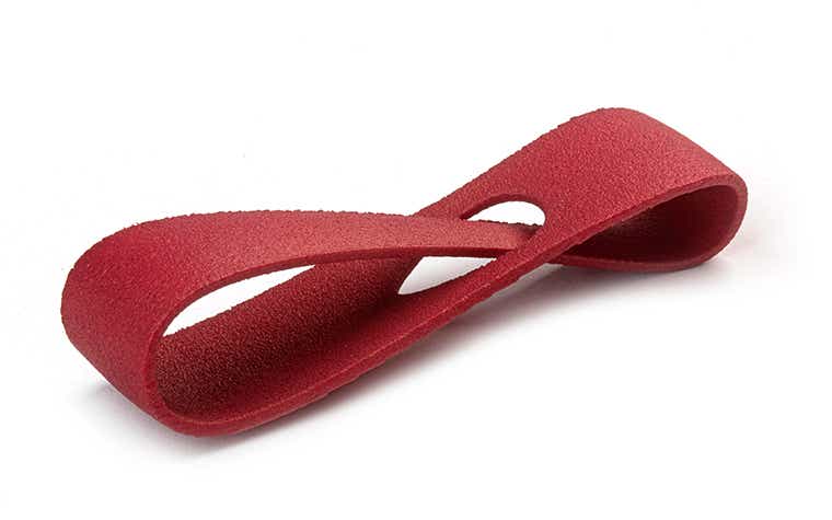 A deep Bordeaux red 3D-printed loop made from PA 12 using laser sintering, with a color-dyed finish. 
