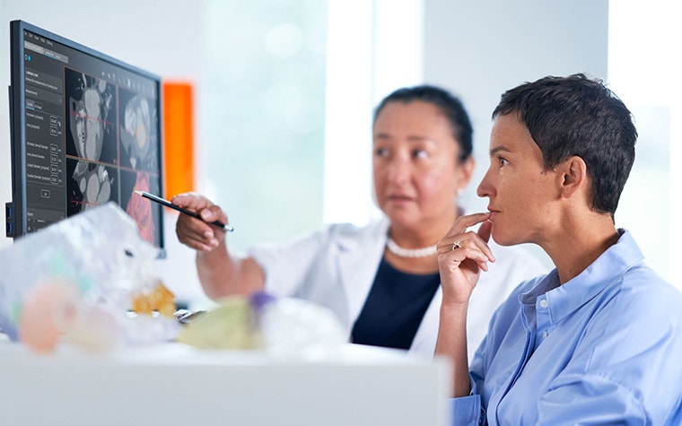 Two people checking software for 3D planning