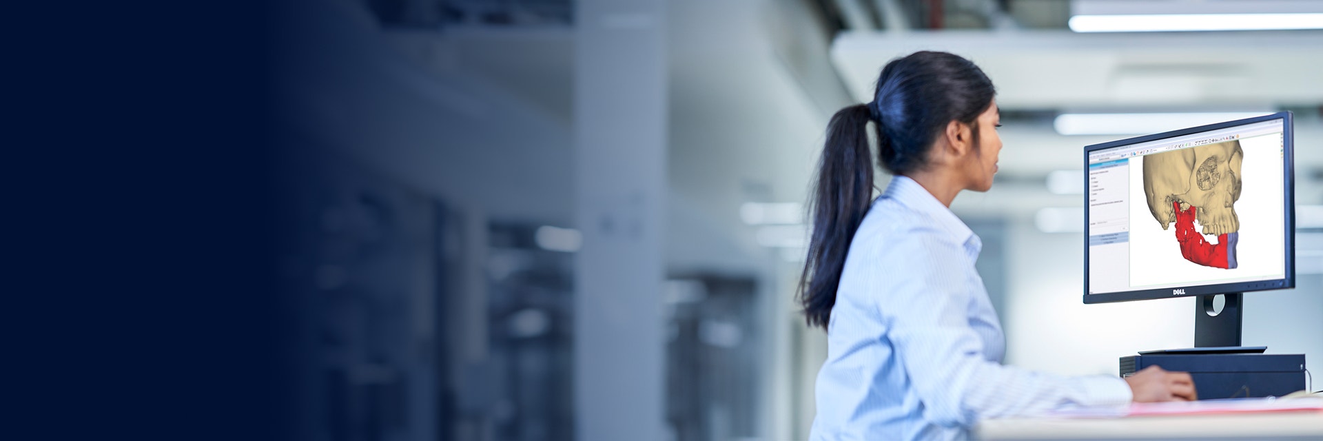 Woman sitting at a computer using CMF planning software