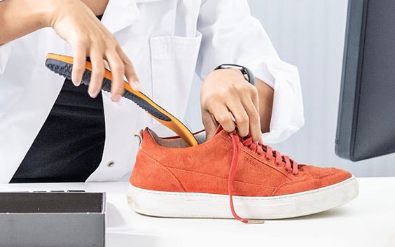 Doctor placing an insole into a shoe