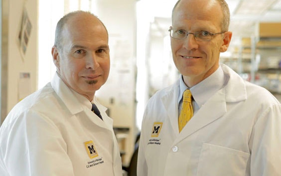 Two male doctors in University of Michigan lab coats