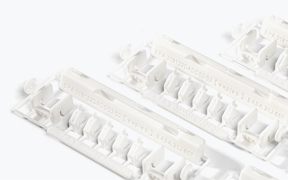 A series of 3D-printed repair kits with EASA 21.J quality labels. The kit contains small white plastic parts made of flame-retardant polyamide, designed by Expleo. These parts are used to replace commonly broken latches on Boeing 737 dado panels. 