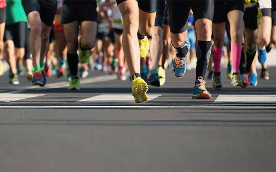 View of runners' legs running as they begin a race