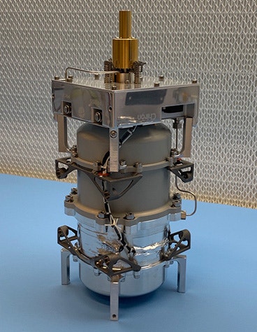 Bradford Space's Comet 1000 propulsion system standing upright on a blue surface.