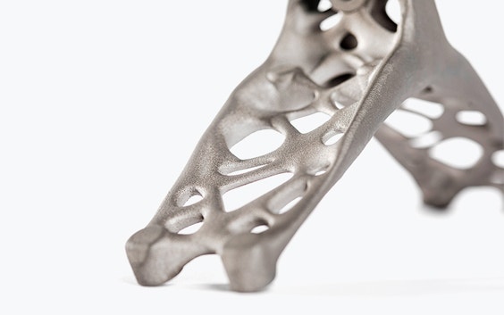 3D-printed lift bracket in titanium with holes for lightweightness