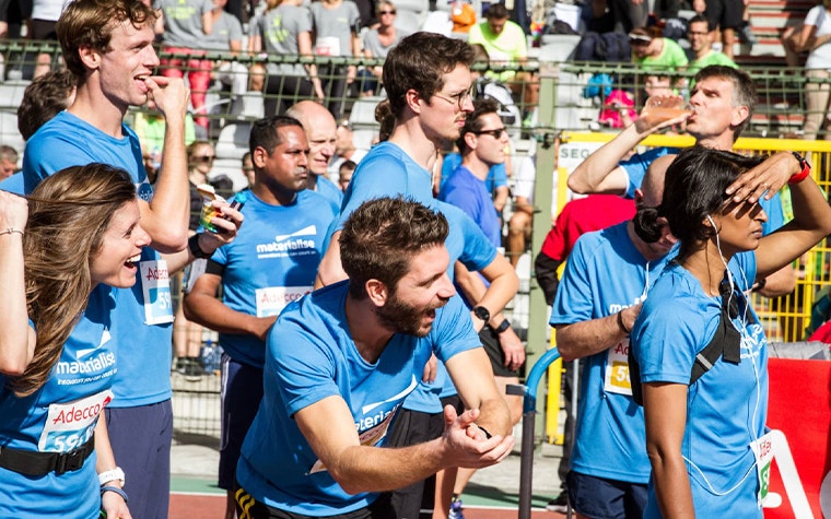 Group of Materialise employees cheering at a race
