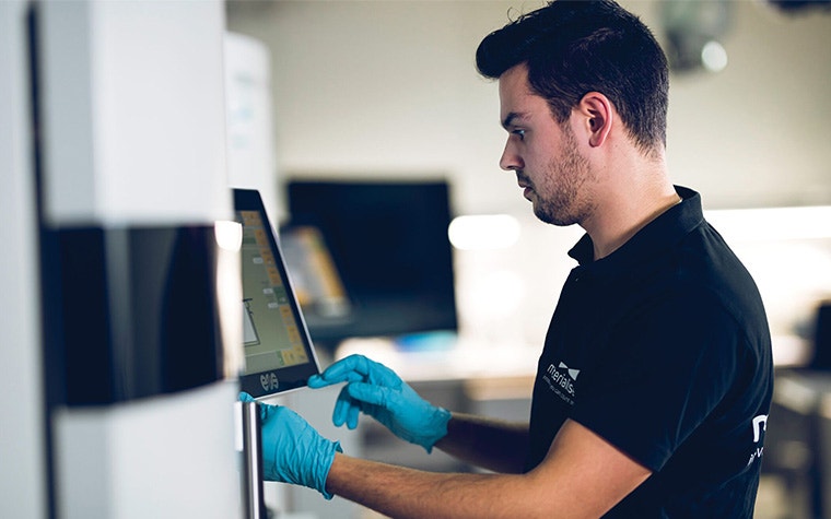 An image of an employee working in a 3D printing facility