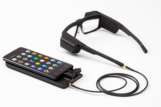 Iristick industrial smart glasses connected to a smartphone via a cabled docking station 