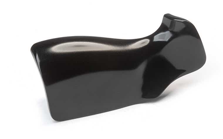 A slightly shiny black handle made with ABS-like Polyurethanes using vacuum casting, finished with primer and glossy satin paint.