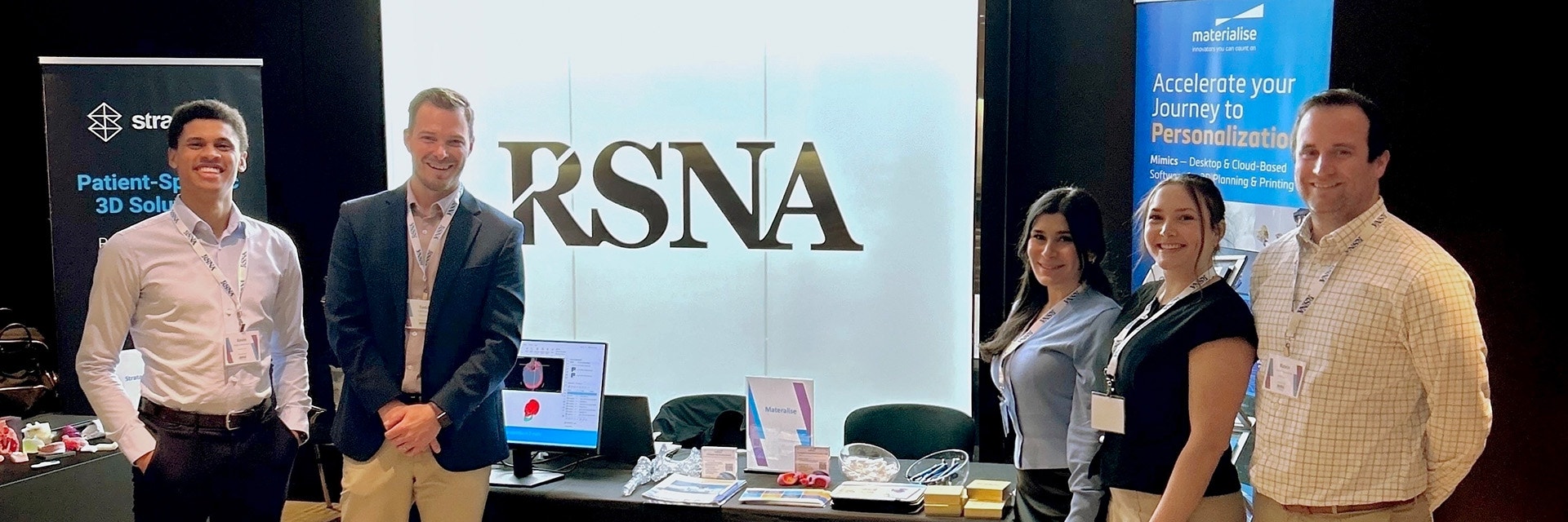 The Materialise team posing at their booth during the RSNA event.