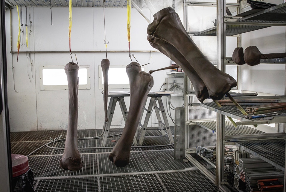 3D-printed mammoth bones hanging to dry after being painted 