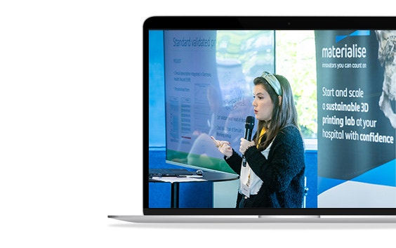 An image of María Gloria Álvarez Caballero speaking at the 3D Printing in Hospitals Forum 2024 shown on a laptop screen