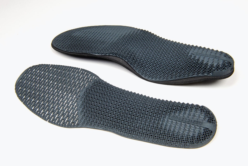 Two custom, 3D-printed insoles side by side, one with more support than the other