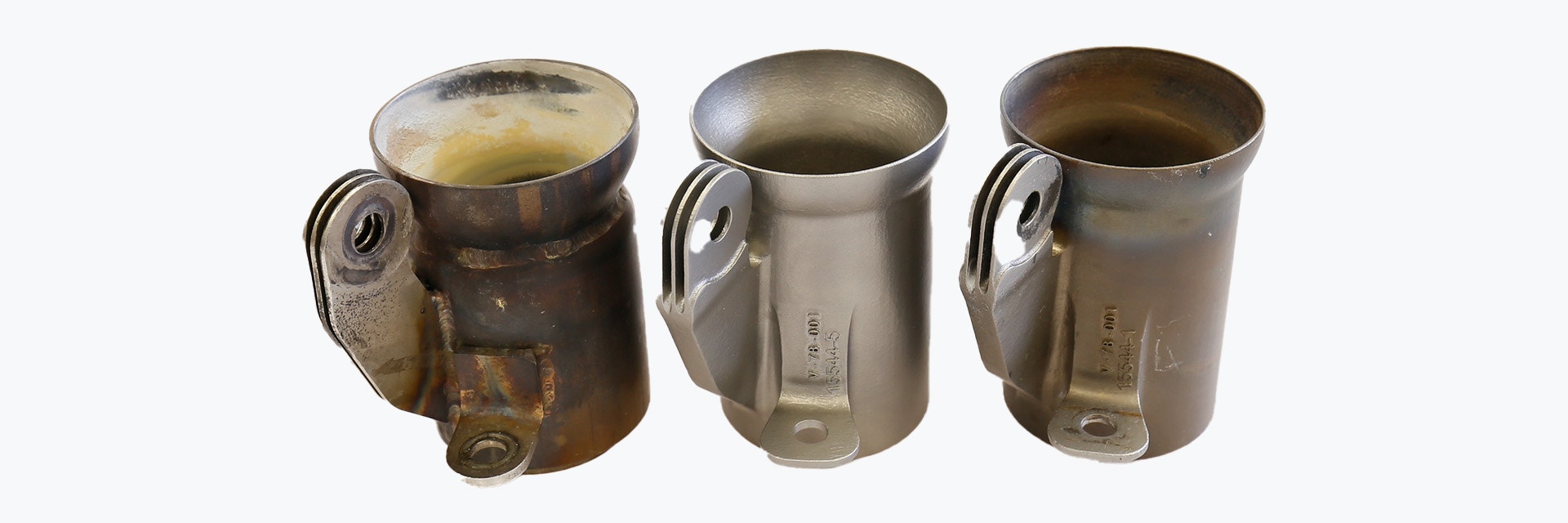 Three metal muffler couplers for powered gliders. One produced with traditional manufacturing methods, two metal 3D-printed in Inconel by Vocus.