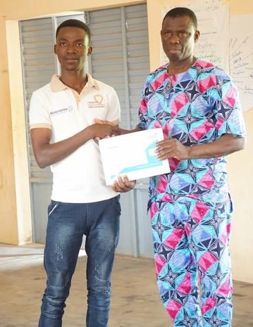 Benin Summer School Student 2019, Modeste Motse, shaking hands with his teacher