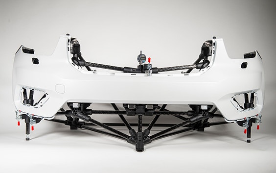 White car bumper mounted on a lightweight, modular quality checking fixture with carbon fiber rods and 3D-printed modular connectors.

