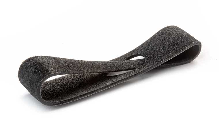 Eine schwarze 3D-gedruckte Schleife aus Verbundwerkstoffen, die mit PolyJet hergestellt wurde, mit einer einfachen Oberfläche.