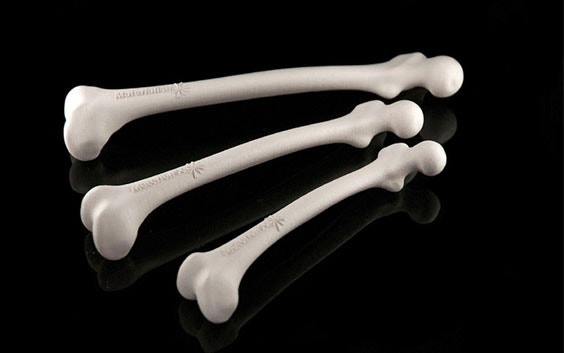 Three 3D-printed bone models with the Materialise logo on them