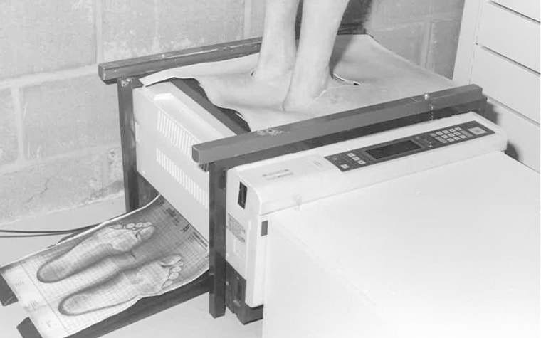 Black and white image of a person print images of their feet