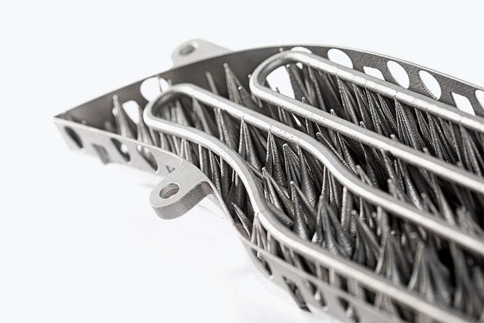 Underside of a 3D-printed metal lamination tool with cooling channels for automotive use