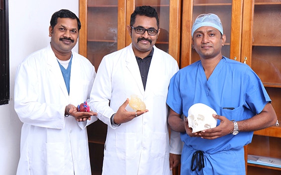 AIMS team holding 3D-printed anatomical models 