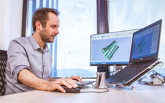A man using a desktop computer with the magics essentials software