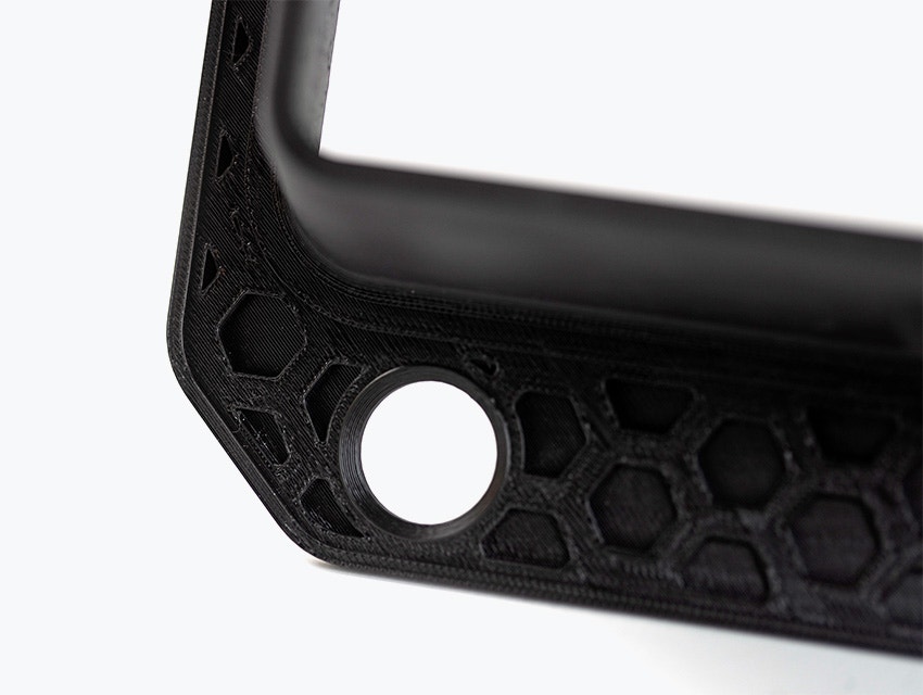 A black 3D-printed airduct frame made in PC-ABS using fused deposition modeling.