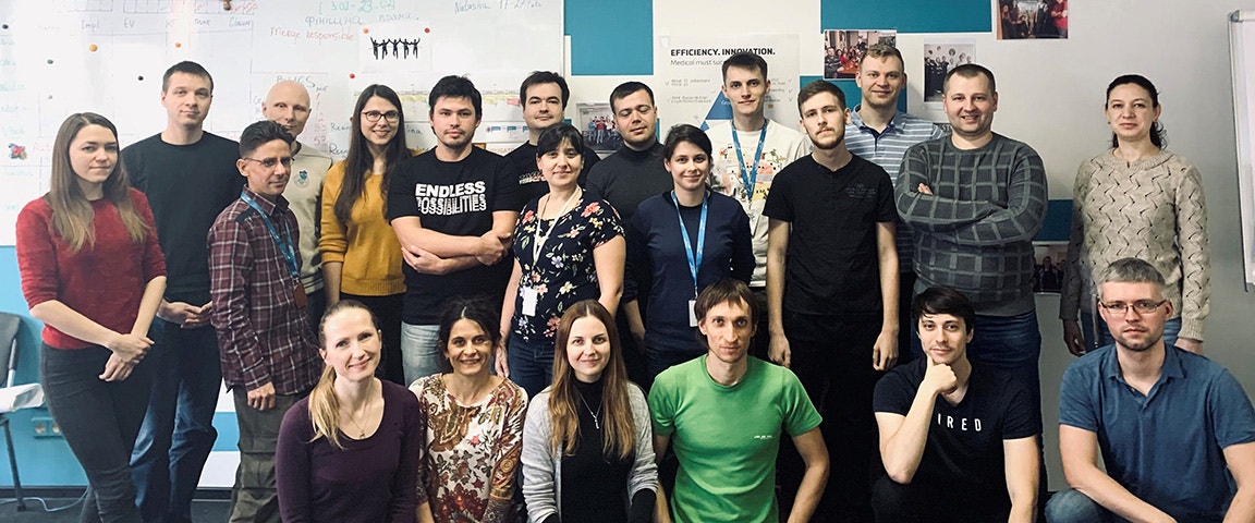 The Mimics Enlight and CMF software development teams in Ukraine. A group of men and woman are posing for the camera.