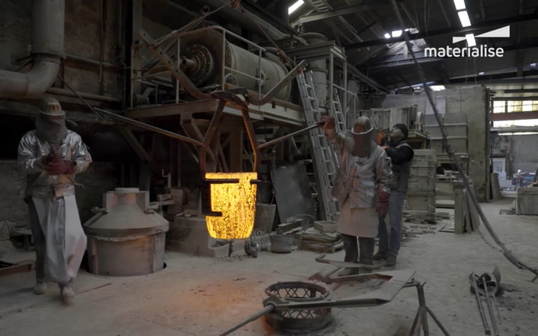 Workers in a foundry in the middle of an investment casting process