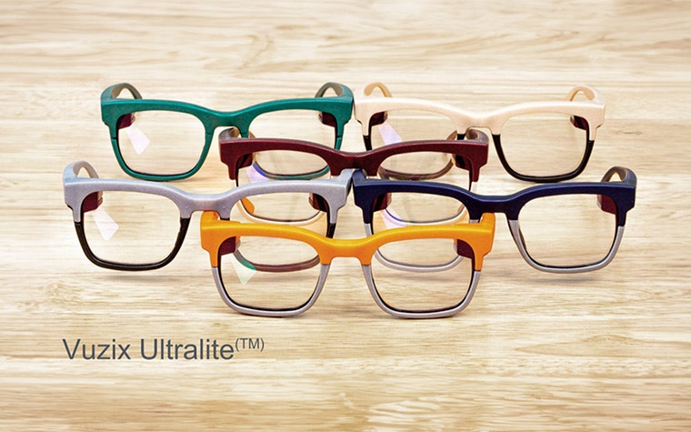 Collection of Vuzix Ultralite eyewear frames on a wood table