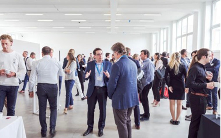 Crowd of people standing and speaking at the 3D Printing in Hospitals Forum 2022