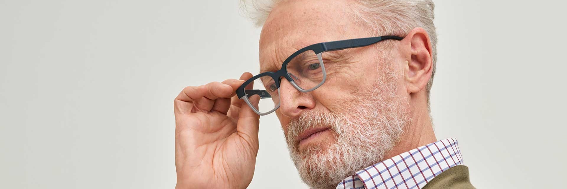 Older man wearing 3D-printed autofocal eyewear from Morrow