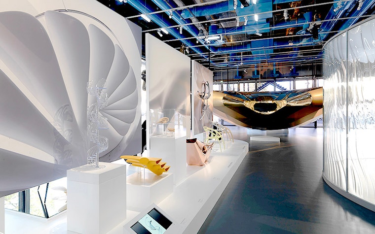 Various sculptures on a table in a hallway of the exhibition