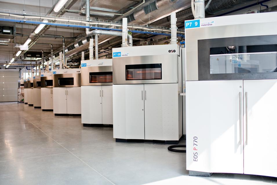 A row of EOS 3D printers in a Materialise production area