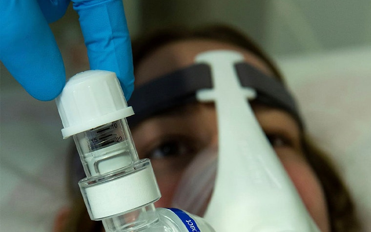 Oxygen mask with 3D-printed components on a patient in bed