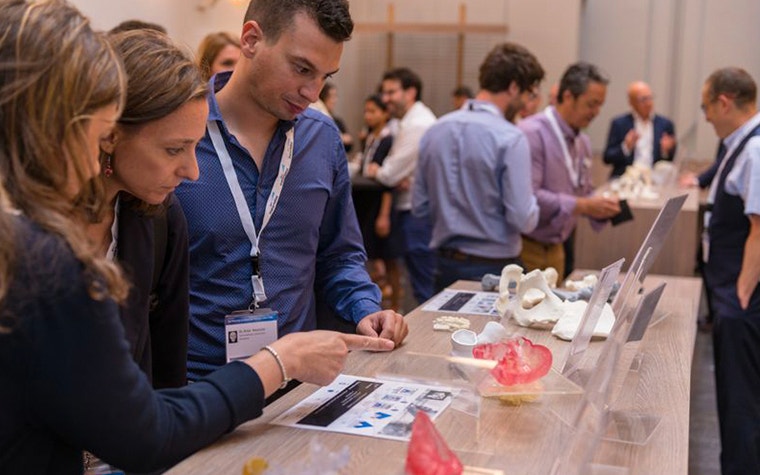 3D Printing in Medicine participants looking at a display of 3D-printed anatomical models