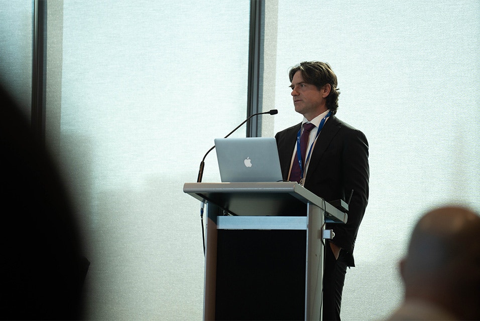 Keynote speaker Dr. Michael Wagels at a podium during the 3D Printing in Hospitals Forum 2024