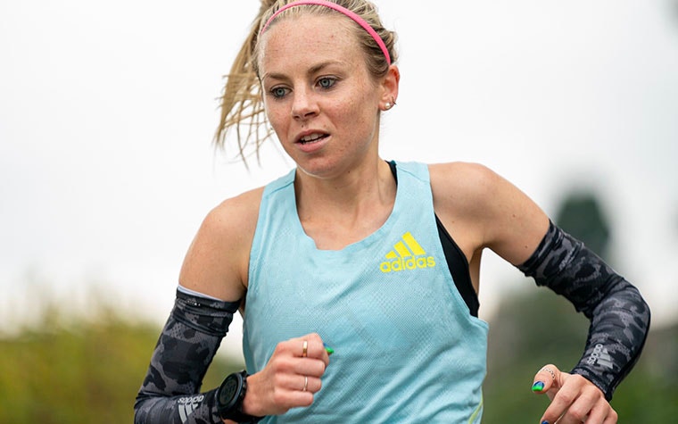 Woman running in Adidas gear