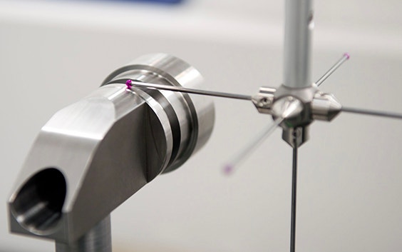 Close up view of a CMM Machine probe precisely measuring a milled part. 