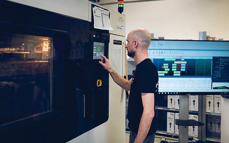 Man using a touchscreen on a 3D printer