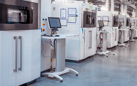 Fila di stampanti 3D per sinterizzazione laser EOS in uno stabilimento di produzione Materialise