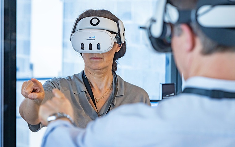 A woman wearing a virtual reality headset at the Materialise CMF Innovation Summit.